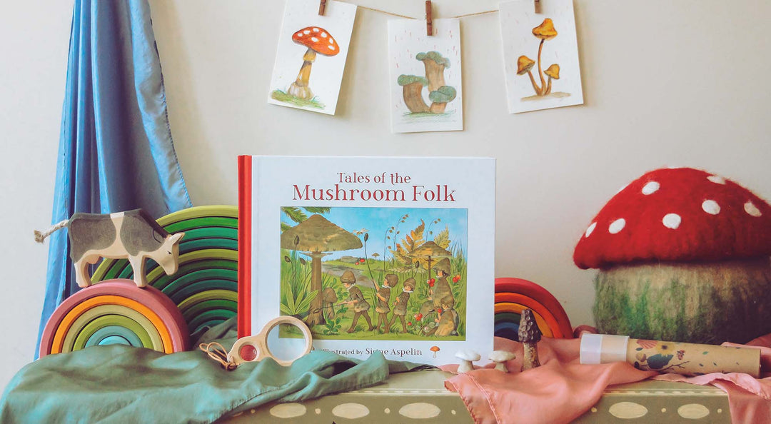 The Tales of the Mushroom Folk book on a shelf with Waldorf toys