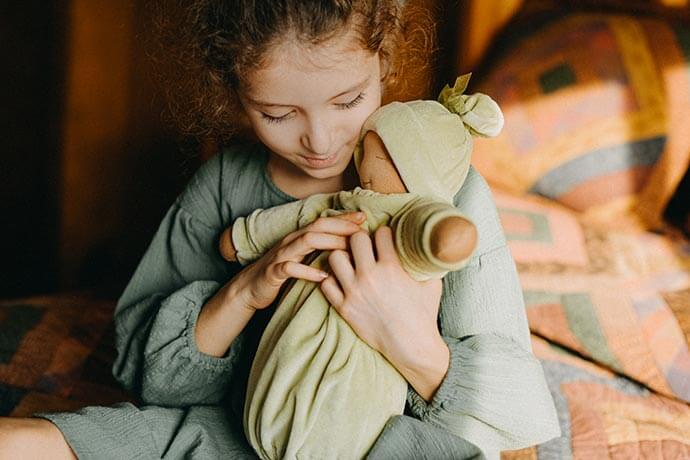 Girl holding Little Heavy Baby